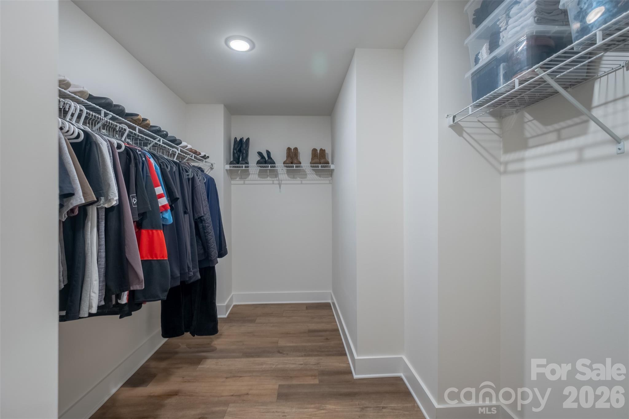 220 Sugar Hill Road Troutman, NC 28166 - Photo 34 of 37 a view of walk in closet with clothes and shoes