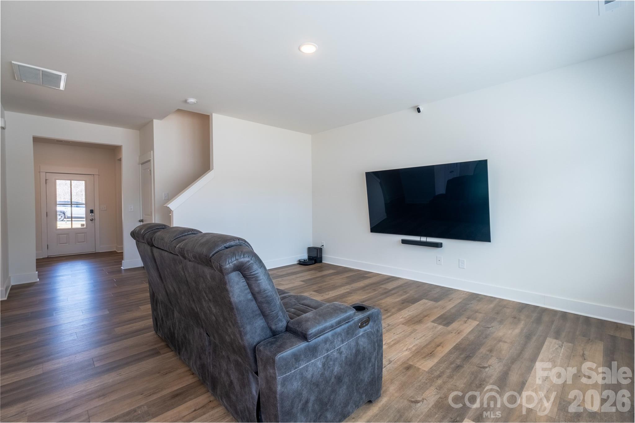 220 Sugar Hill Road Troutman, NC 28166 - Photo 8 of 37 a living room with furniture and a flat screen tv