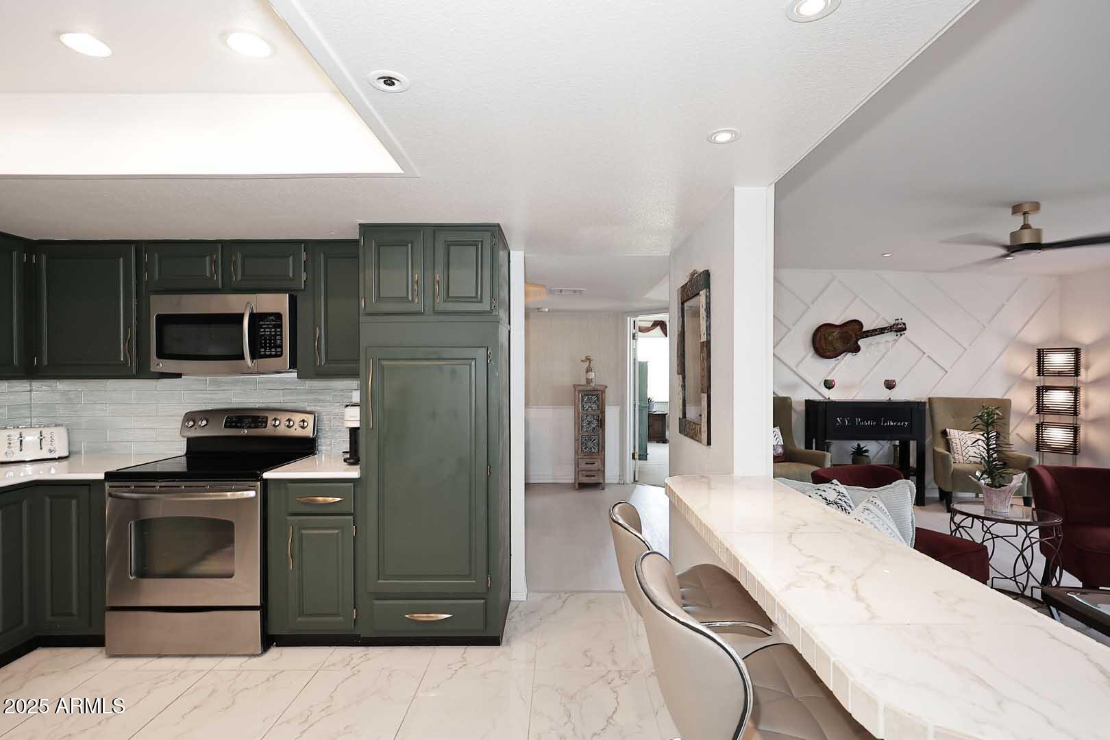 7860 East Camelback Road, Unit 404 Scottsdale, AZ 85251 - Photo 13 of 33 a kitchen with stainless steel appliances kitchen island granite countertop a sink and cabinets
