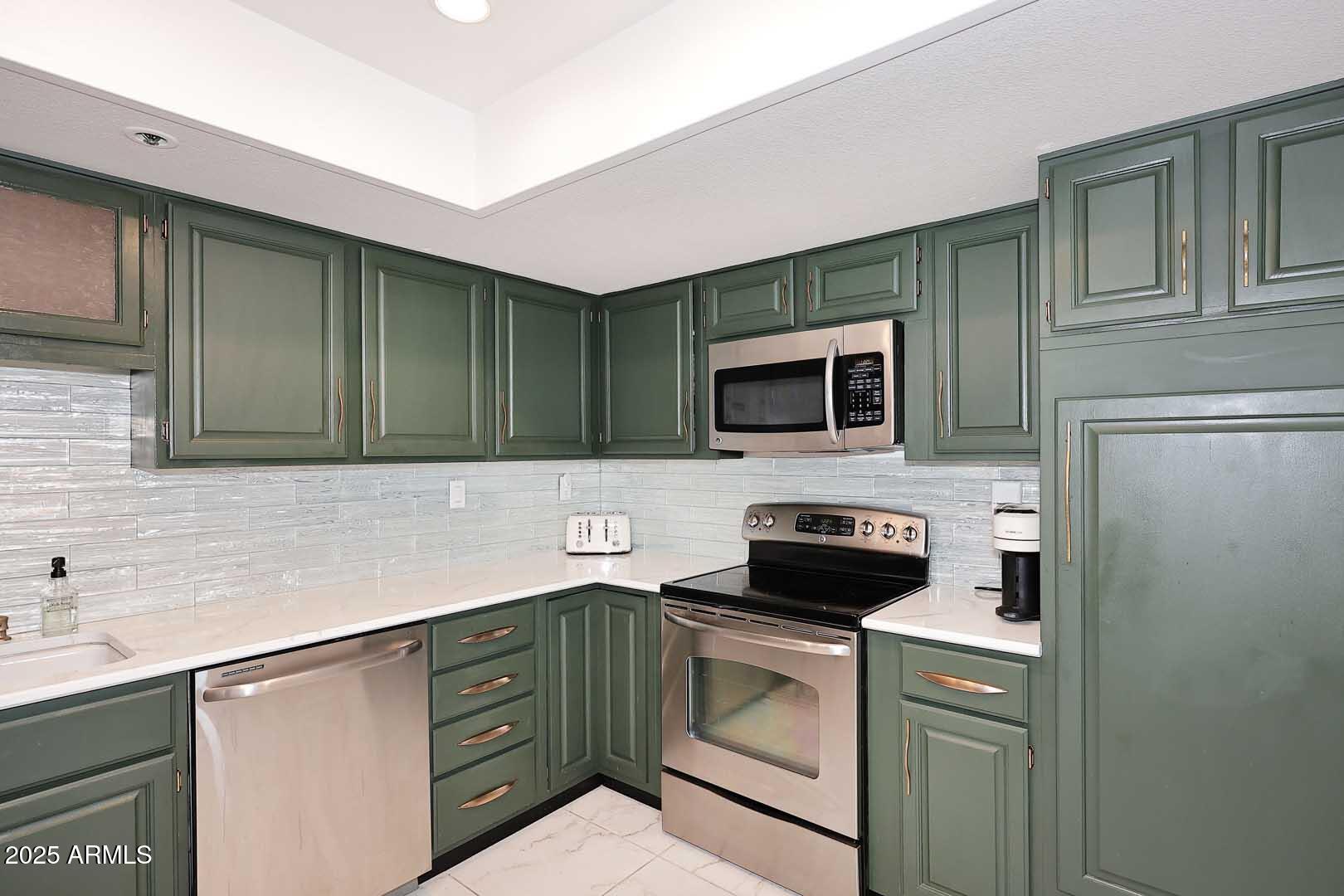 7860 East Camelback Road, Unit 404 Scottsdale, AZ 85251 - Photo 14 of 33 a kitchen with a sink and a microwave