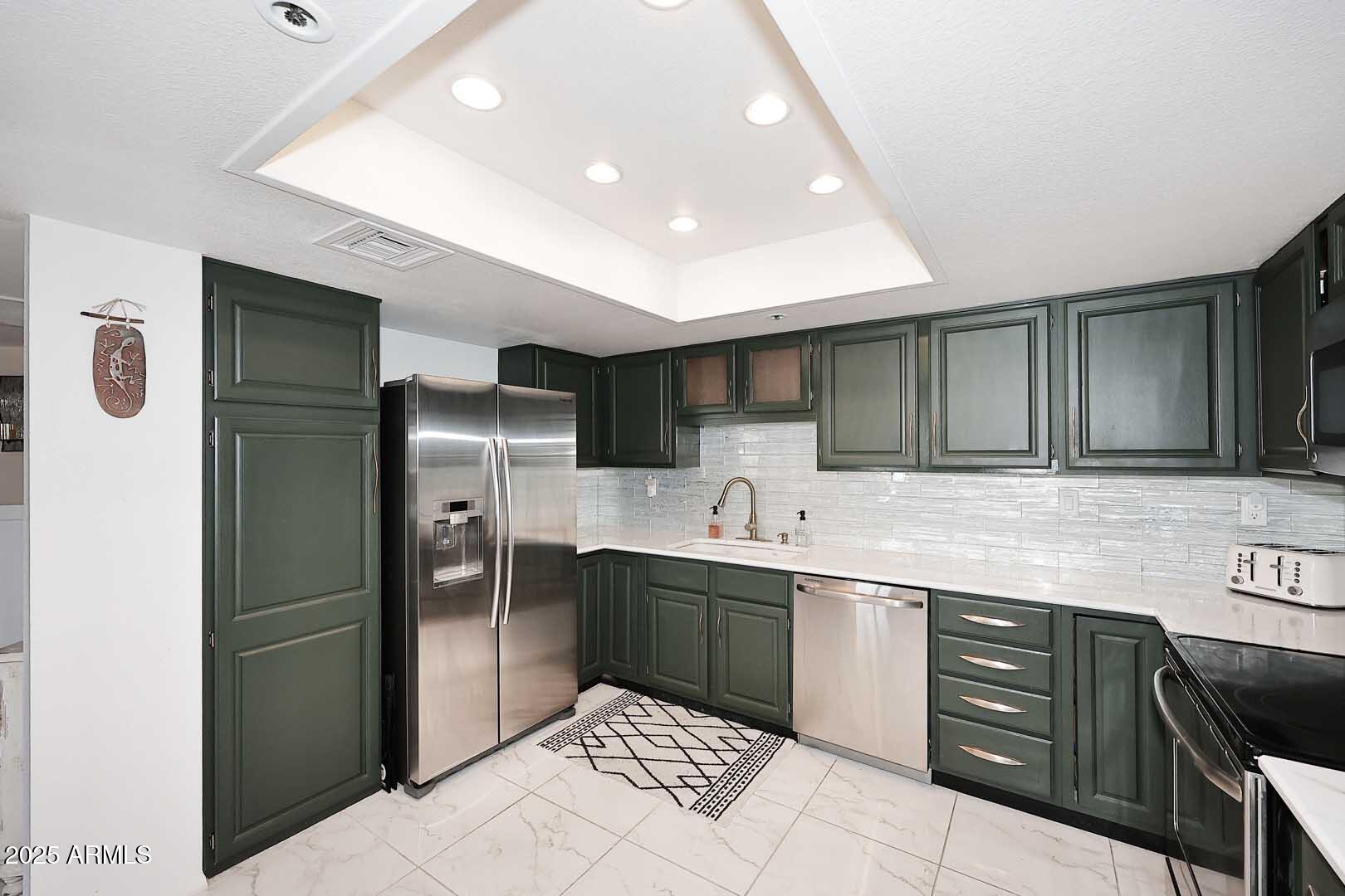 7860 East Camelback Road, Unit 404 Scottsdale, AZ 85251 - Photo 15 of 33 a kitchen with stainless steel appliances granite countertop a sink and cabinets