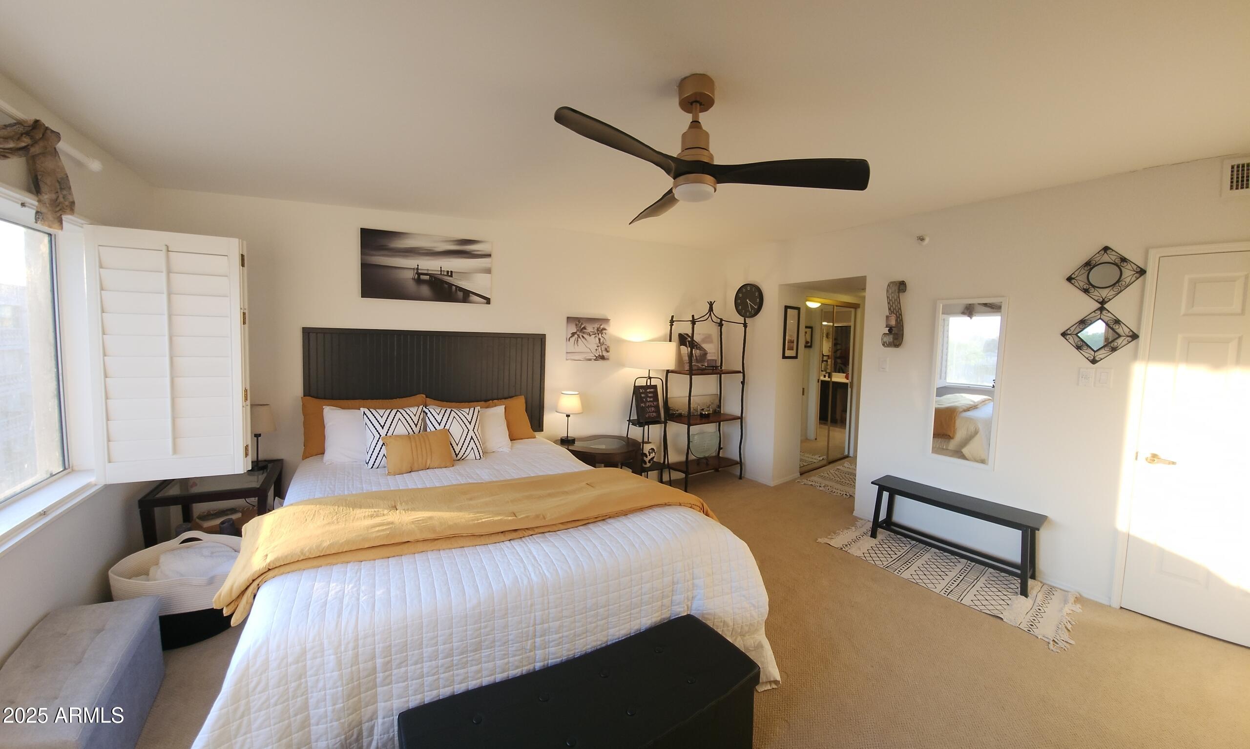 7860 East Camelback Road, Unit 404 Scottsdale, AZ 85251 - Photo 16 of 33 a bed room with a bed and a chandelier