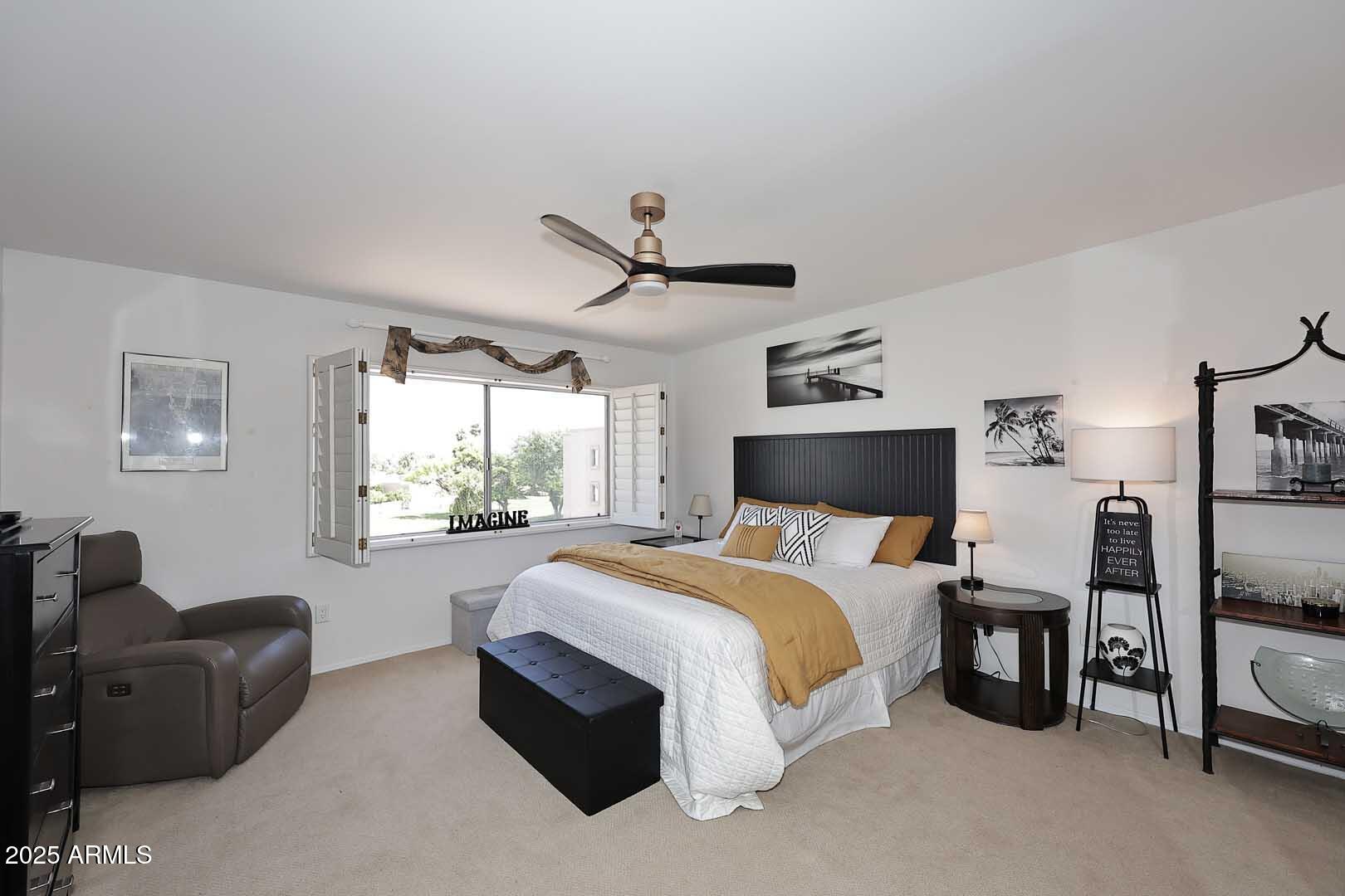7860 East Camelback Road, Unit 404 Scottsdale, AZ 85251 - Photo 17 of 33 a spacious bedroom with a bed and a couch