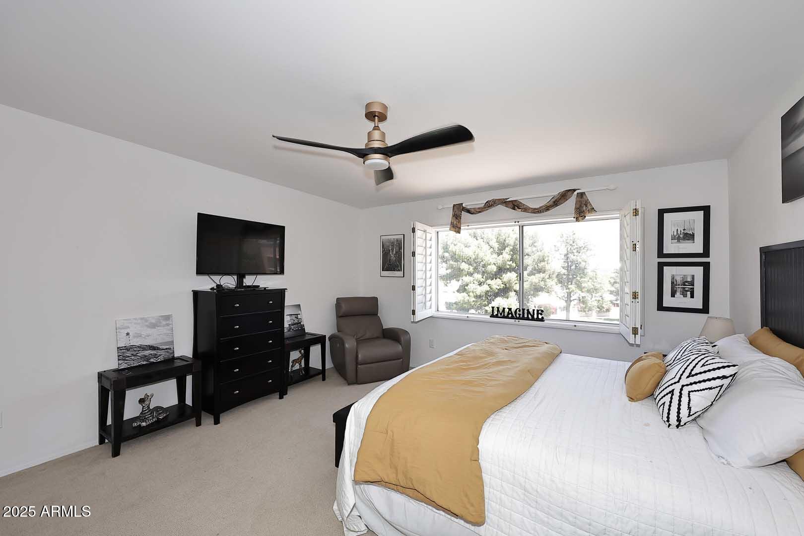 7860 East Camelback Road, Unit 404 Scottsdale, AZ 85251 - Photo 18 of 33 a spacious bedroom with a bed and a flat screen tv