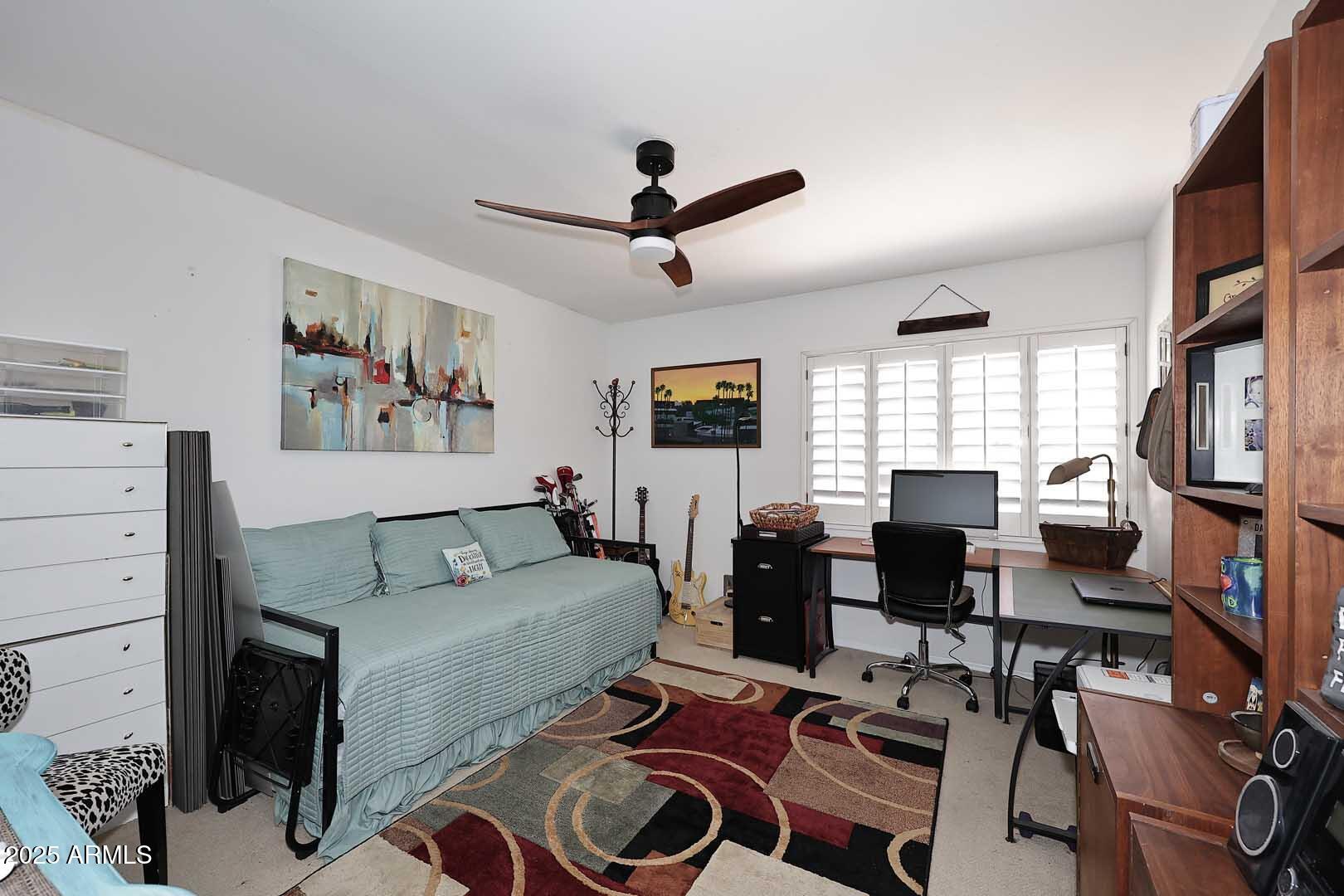 7860 East Camelback Road, Unit 404 Scottsdale, AZ 85251 - Photo 20 of 33 a living room with furniture a flat screen tv and a window