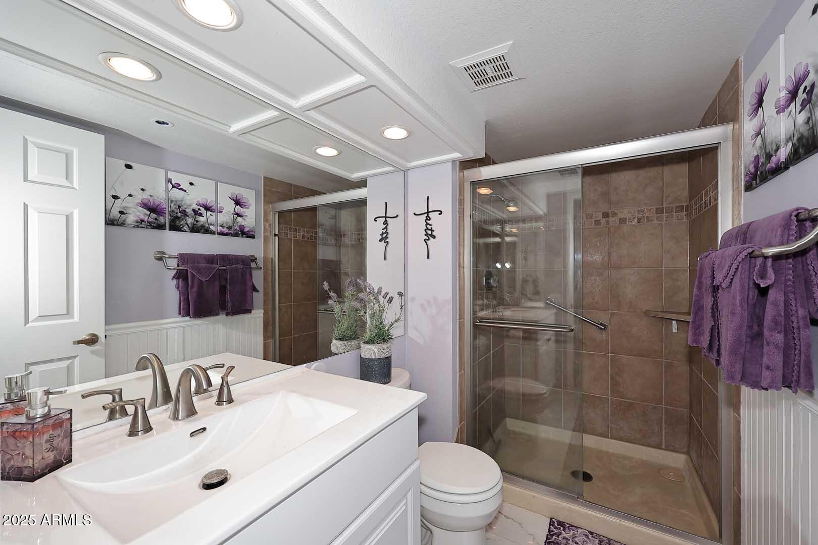 7860 East Camelback Road, Unit 404 Scottsdale, AZ 85251 - Photo 21 of 33 a bathroom with a shower sink mirror and toilet