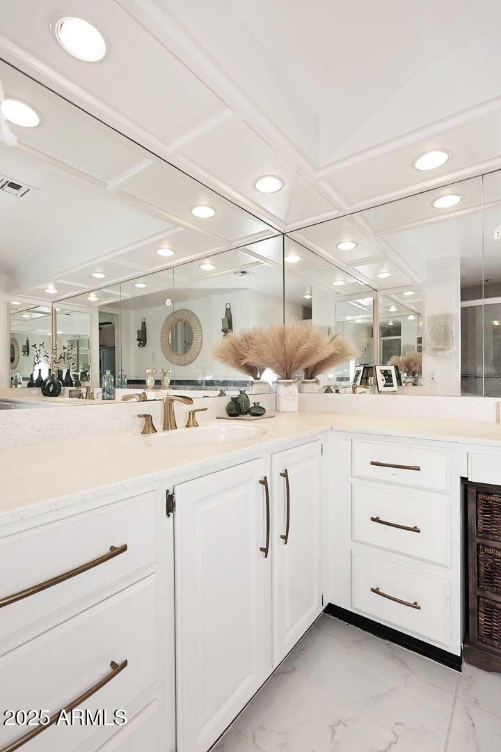 7860 East Camelback Road, Unit 404 Scottsdale, AZ 85251 - Photo 25 of 33 a bathroom with a sink a mirror and a vanity