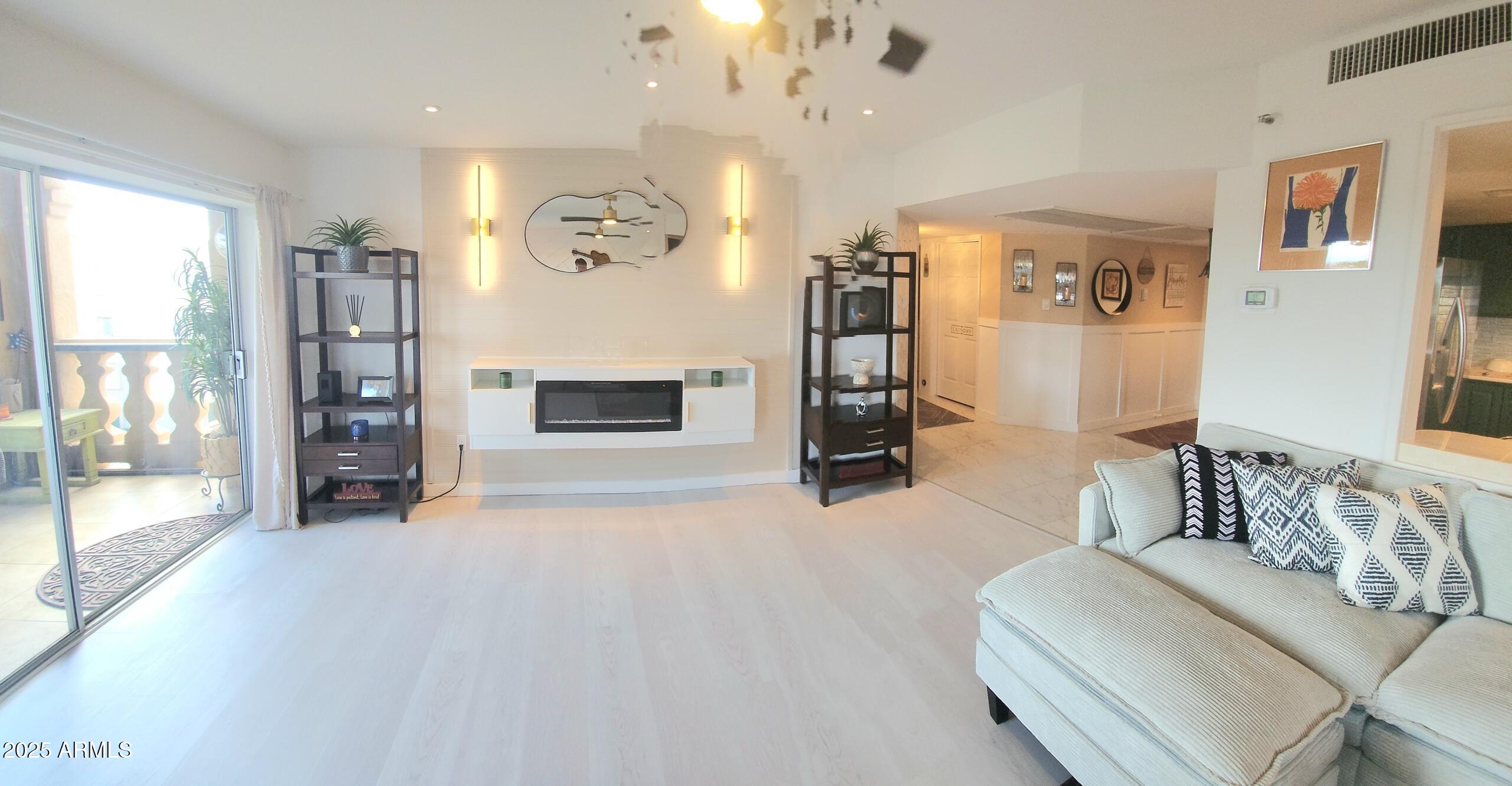 7860 East Camelback Road, Unit 404 Scottsdale, AZ 85251 - Photo 6 of 33 a living room with furniture and a flat screen tv