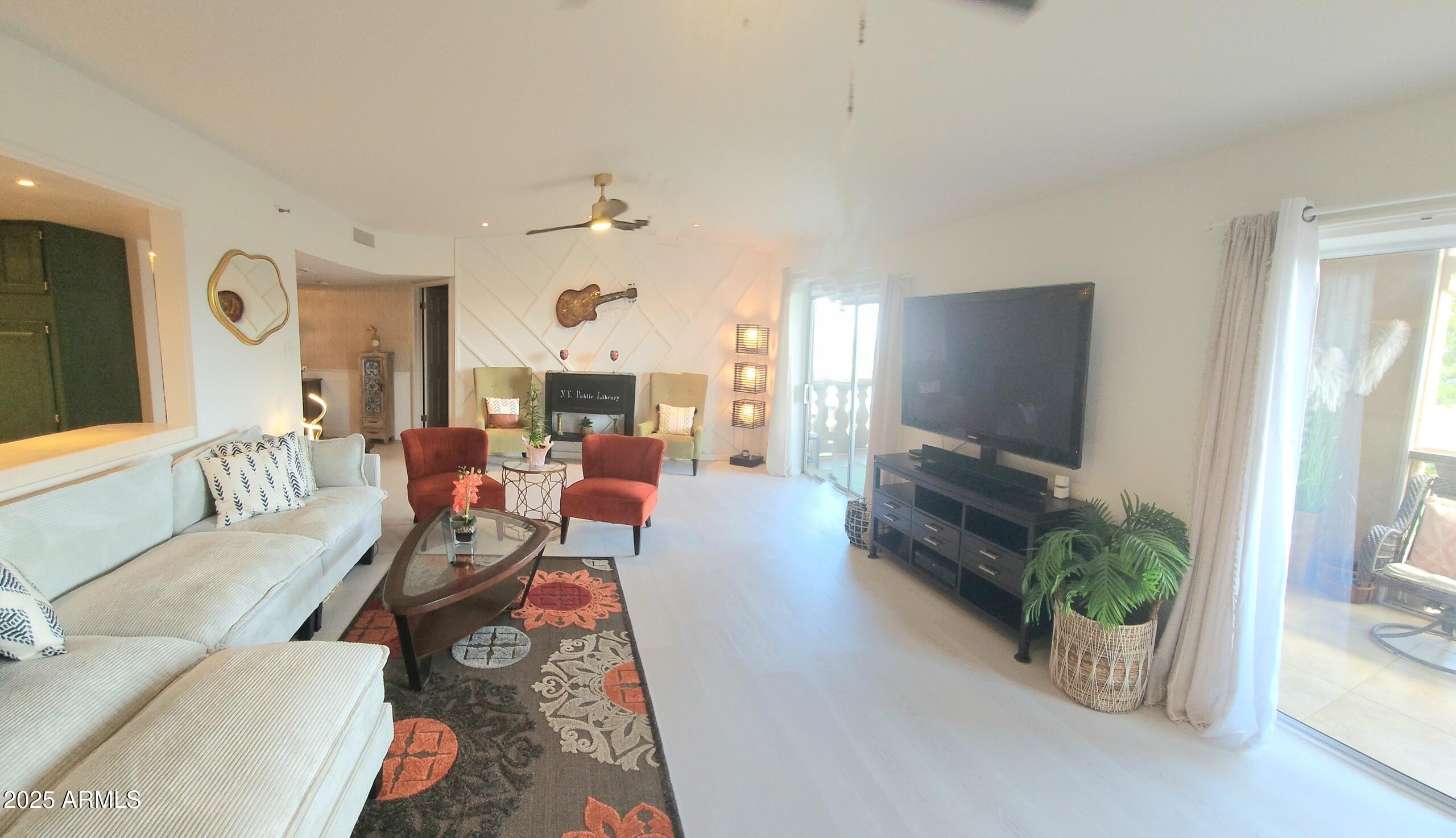 7860 East Camelback Road, Unit 404 Scottsdale, AZ 85251 - Photo 7 of 33 a living room with furniture and a flat screen tv