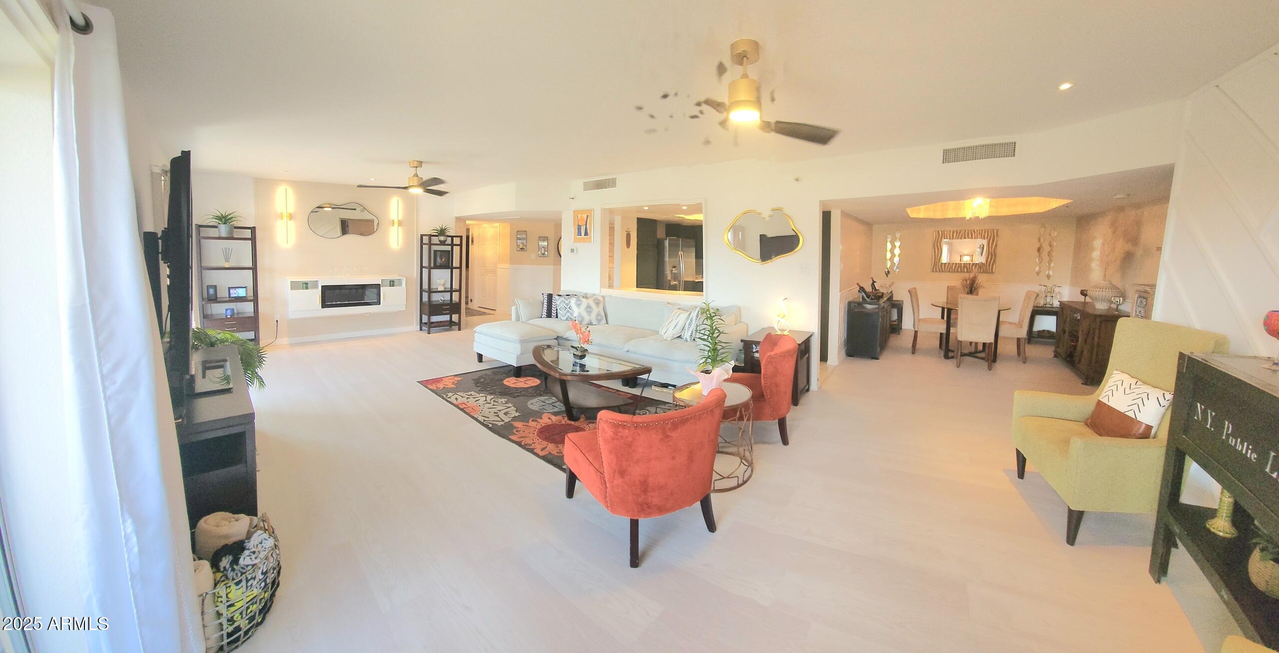 7860 East Camelback Road, Unit 404 Scottsdale, AZ 85251 - Photo 8 of 33 a living room with furniture and a chandelier