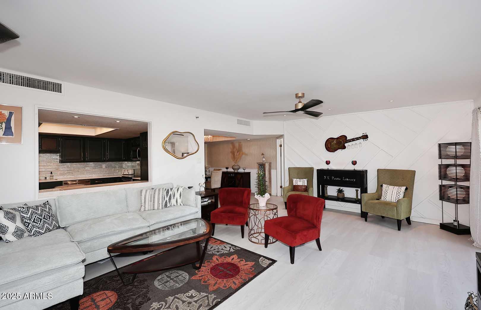 7860 East Camelback Road, Unit 404 Scottsdale, AZ 85251 - Photo 9 of 33 a living room with furniture and a flat screen tv