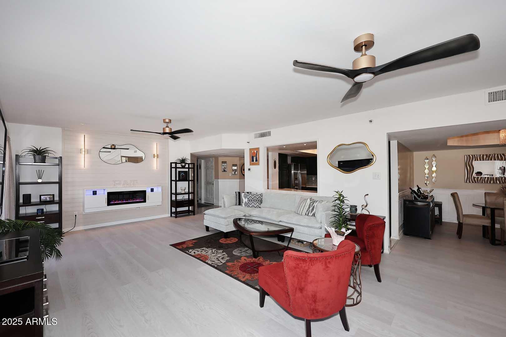 7860 East Camelback Road, Unit 404 Scottsdale, AZ 85251 - Photo 10 of 33 a living room with furniture a rug and a ceiling fan