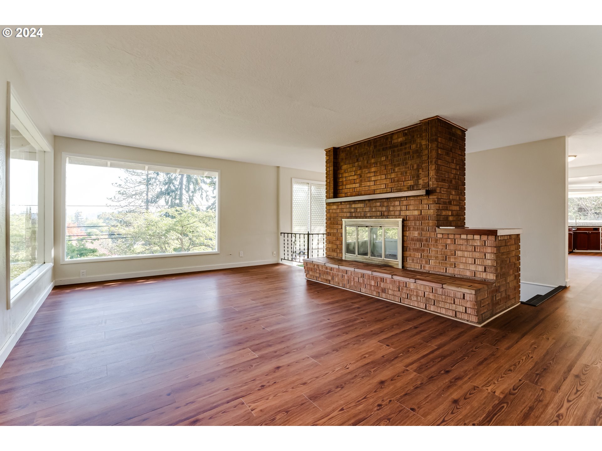 2280 City View Street Eugene, OR 97405 - Photo 14 of 30 a view of empty room with wooden floor and fireplace