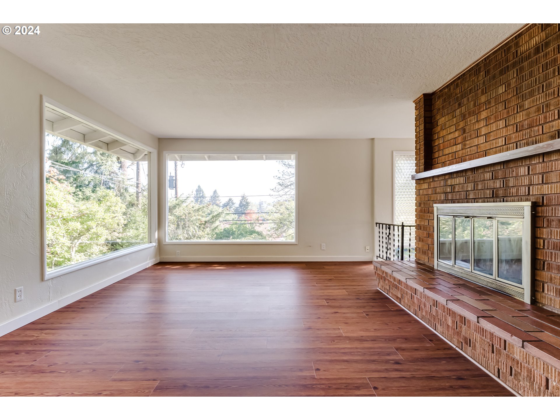 2280 City View Street Eugene, OR 97405 - Photo 15 of 30 a view of an empty room with wooden floor and a fireplace