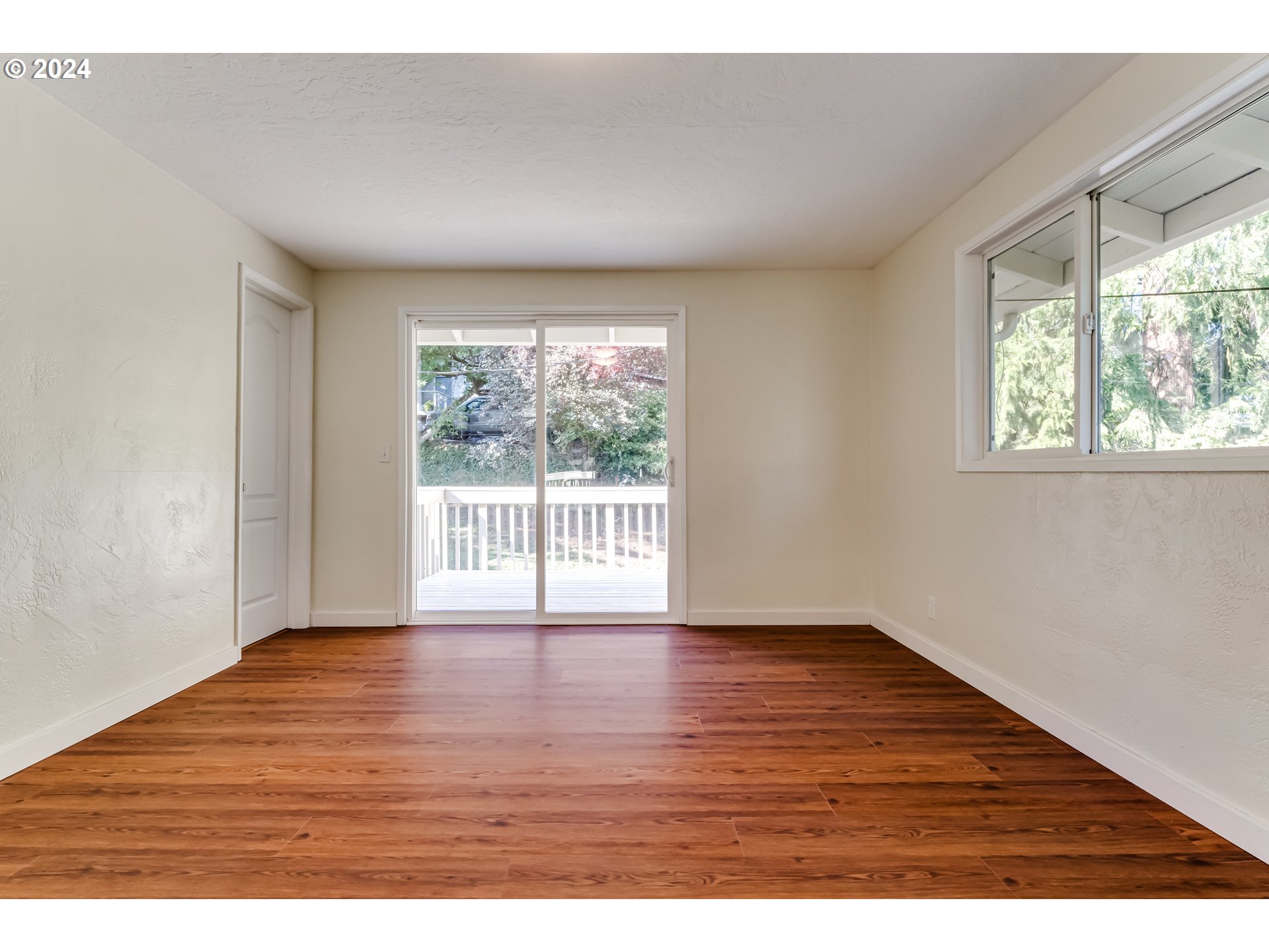 2280 City View Street Eugene, OR 97405 - Photo 18 of 30 a view of an empty room with wooden floor and a window