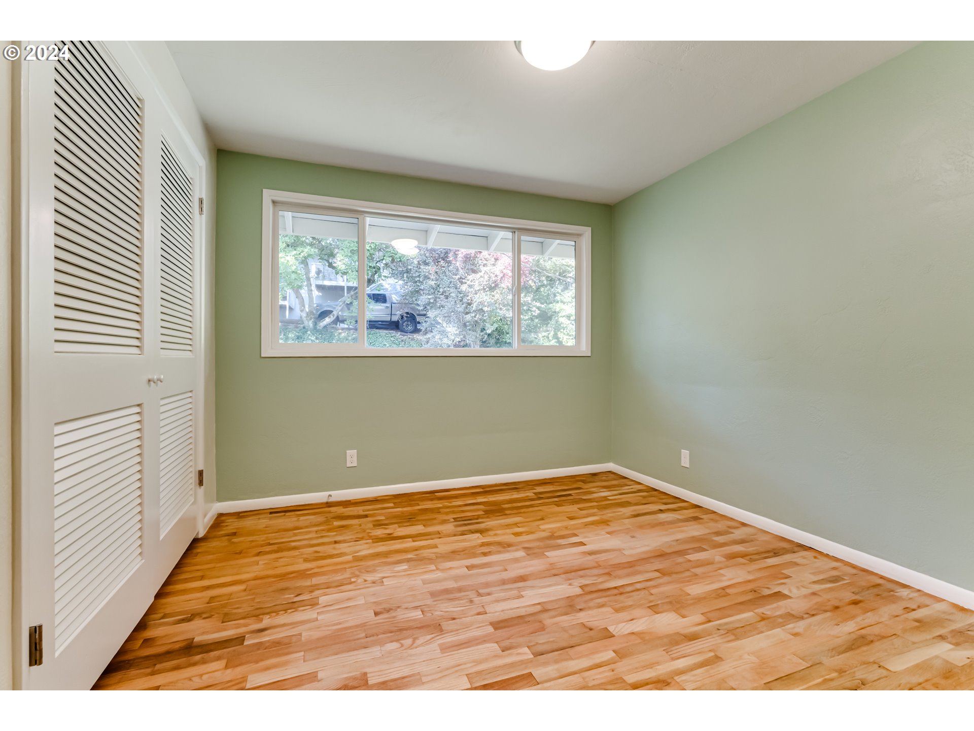 2280 City View Street Eugene, OR 97405 - Photo 24 of 30 an empty room with wooden floor and windows
