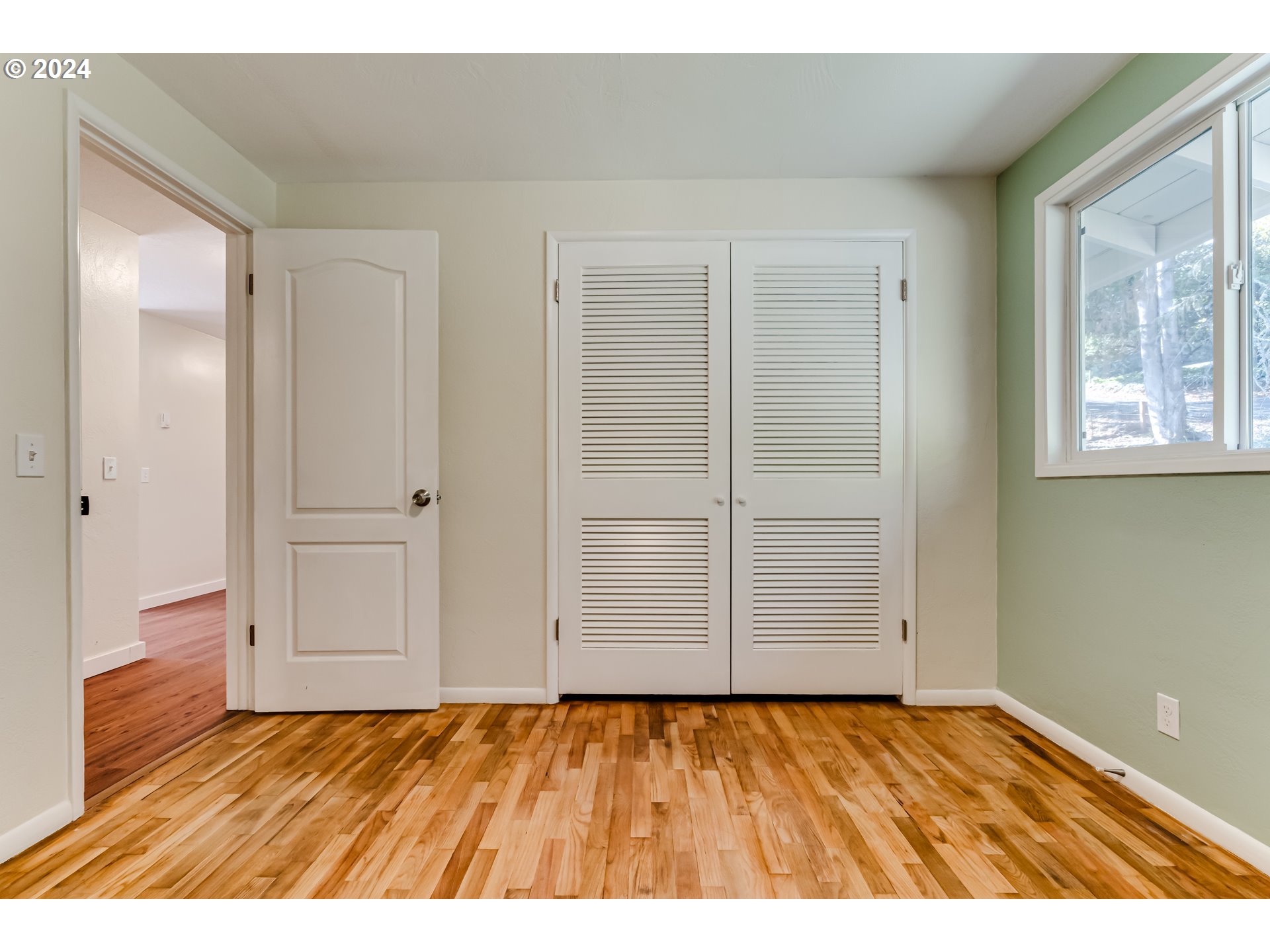 2280 City View Street Eugene, OR 97405 - Photo 26 of 30 a view of an empty room with wooden floor and closet