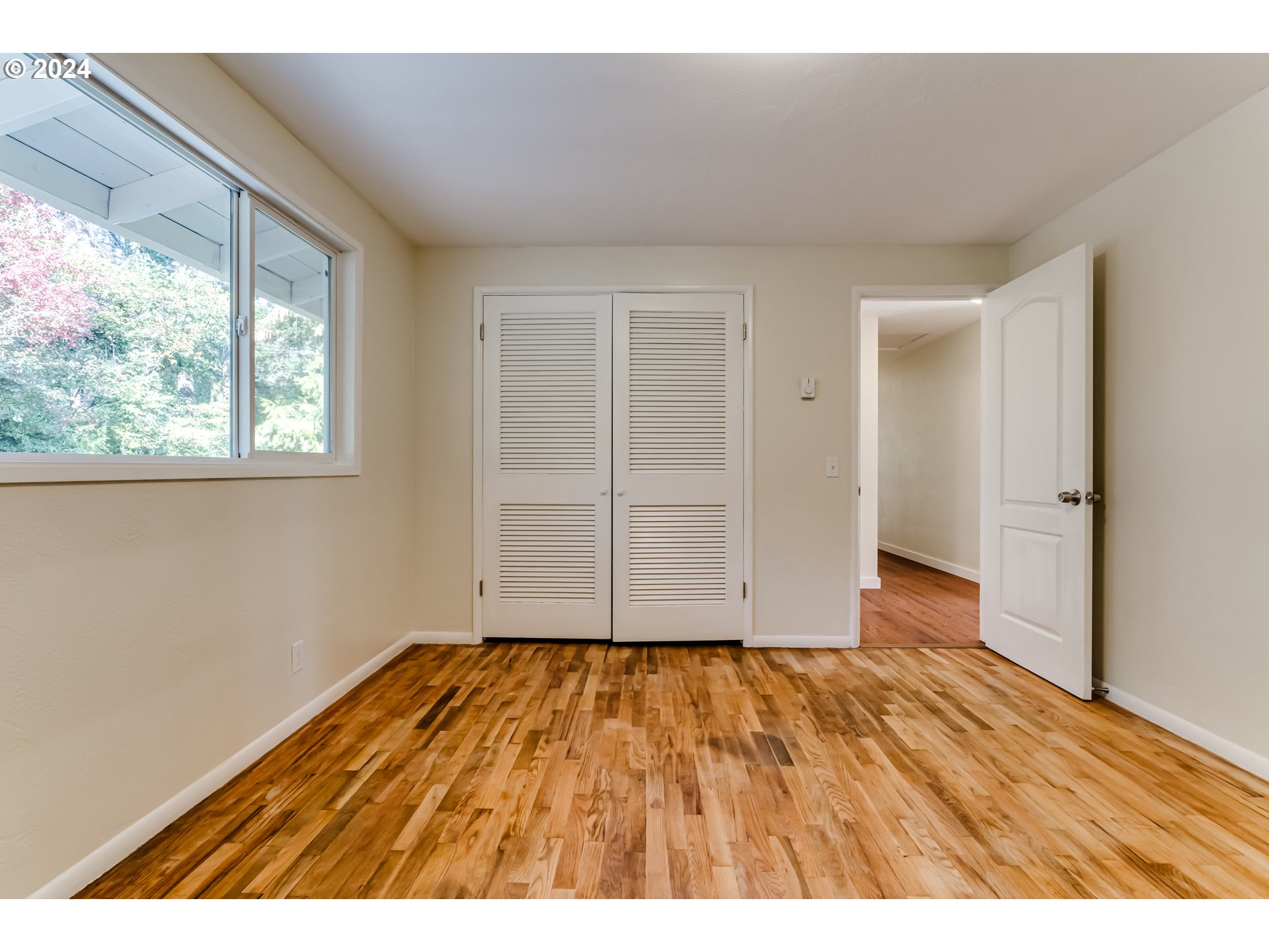 2280 City View Street Eugene, OR 97405 - Photo 28 of 30 a view of an empty room with wooden floor and a window