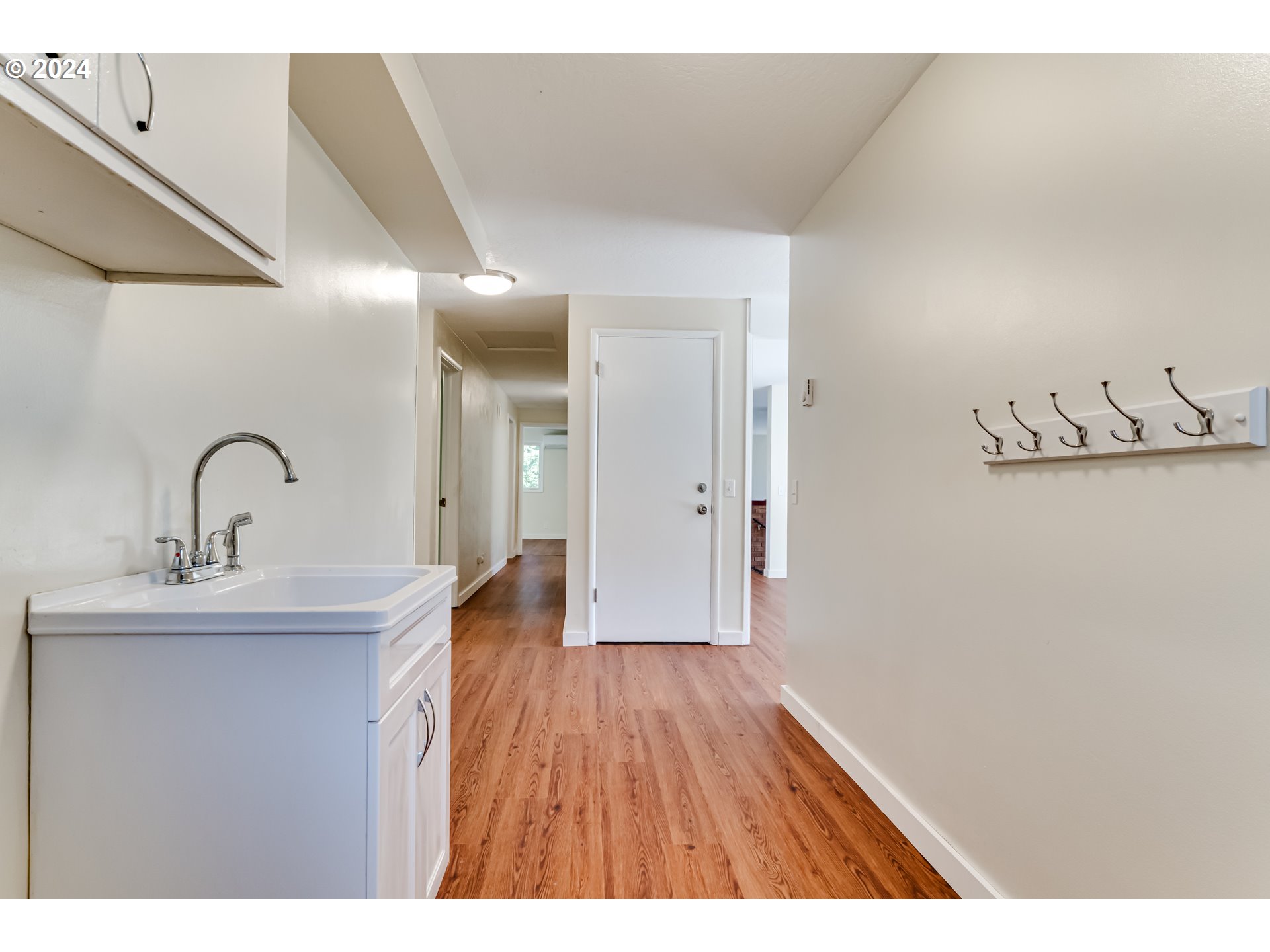 2280 City View Street Eugene, OR 97405 - Photo 30 of 30 a hallway with a sink and wooden floor