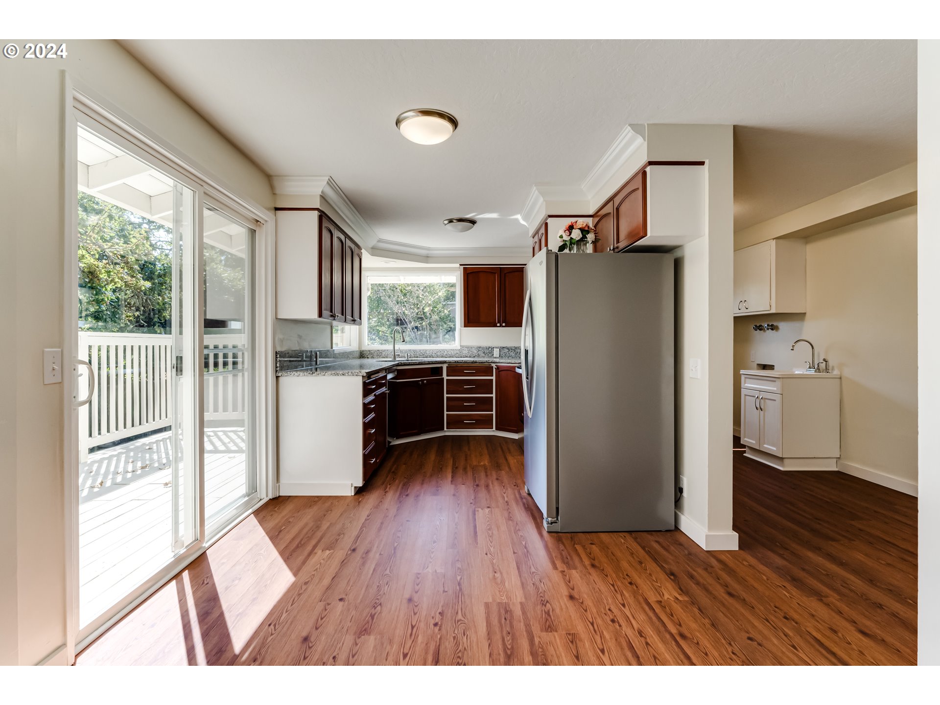 2280 City View Street Eugene, OR 97405 - Photo 8 of 30 a kitchen with a refrigerator a sink and dishwasher with wooden floor