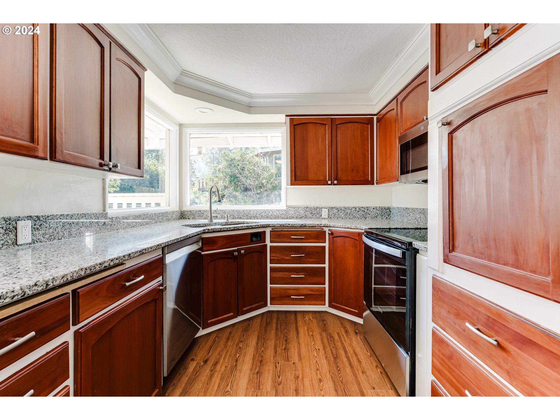 2280 City View Street Eugene, OR 97405 - Photo 10 of 30 a kitchen with granite countertop a sink stove and cabinets