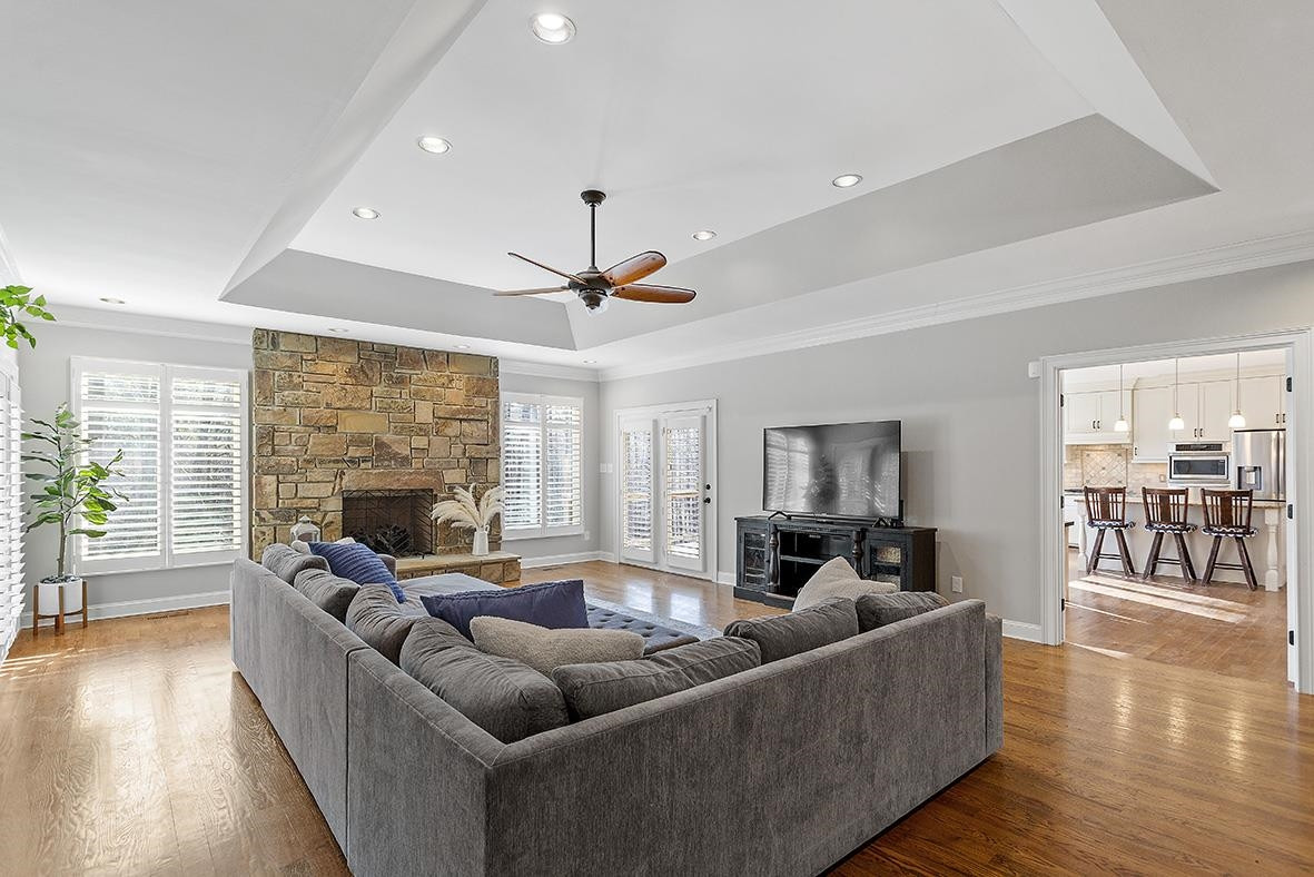 8120 Hawkshead Road Wake Forest, NC 27587 - Photo 17 of 70 a living room with furniture floor to ceiling window and wooden floor