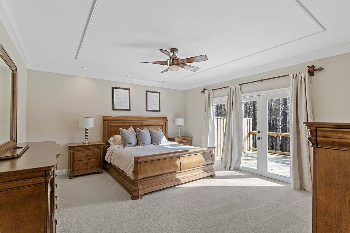 8120 Hawkshead Road Wake Forest, NC 27587 - Photo 30 of 70 a spacious bedroom with a bed and a chandelier