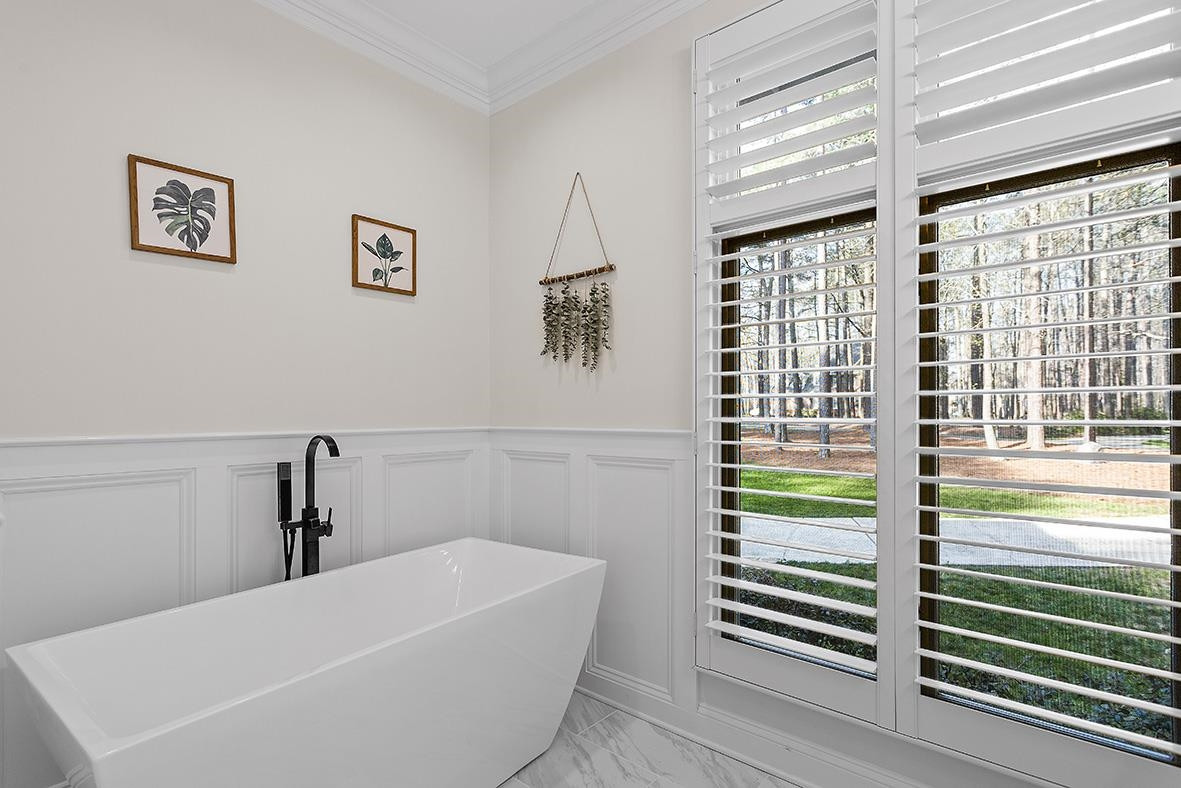 8120 Hawkshead Road Wake Forest, NC 27587 - Photo 33 of 70 a white bath tub sitting next to a window