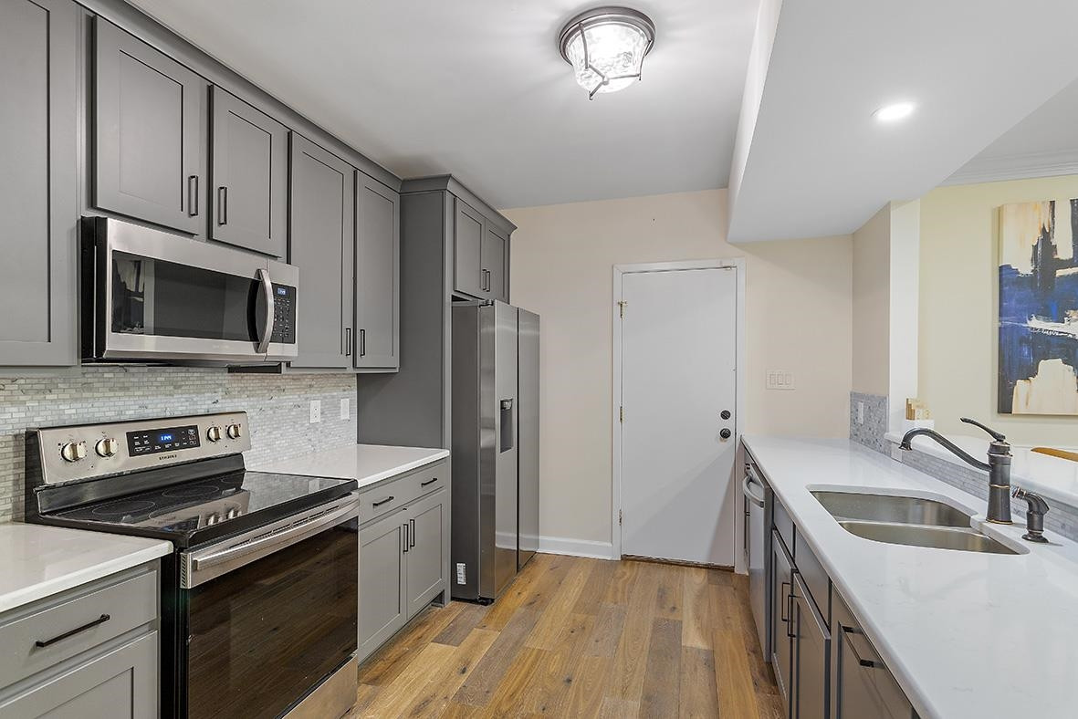 8120 Hawkshead Road Wake Forest, NC 27587 - Photo 43 of 70 a kitchen with a sink stove and refrigerator