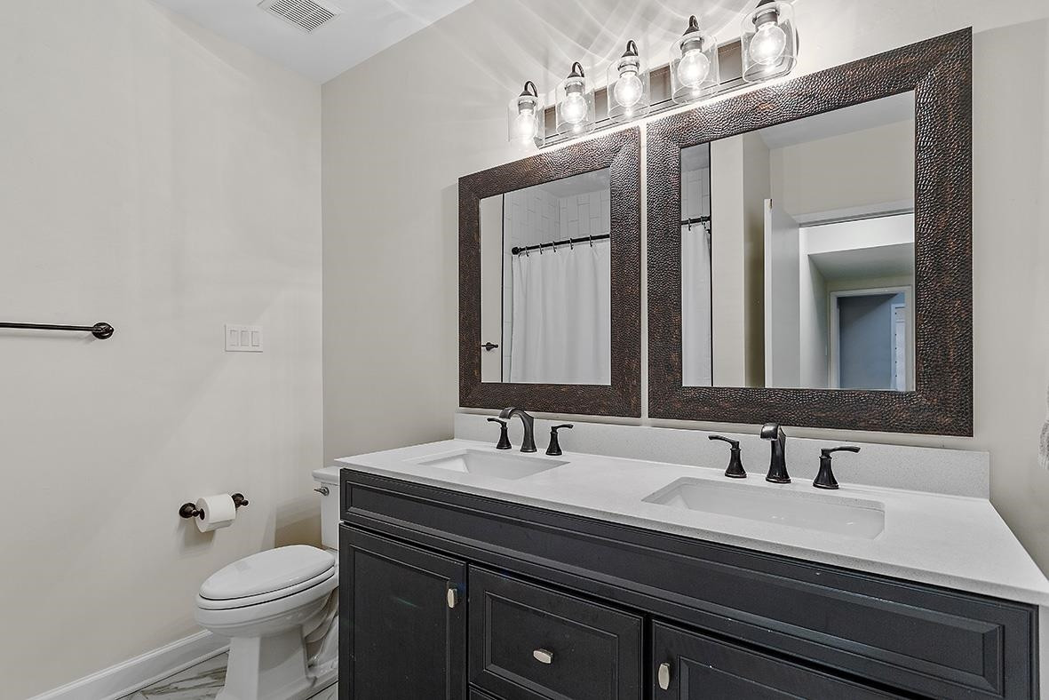8120 Hawkshead Road Wake Forest, NC 27587 - Photo 45 of 70 a bathroom with a sink and a toilet