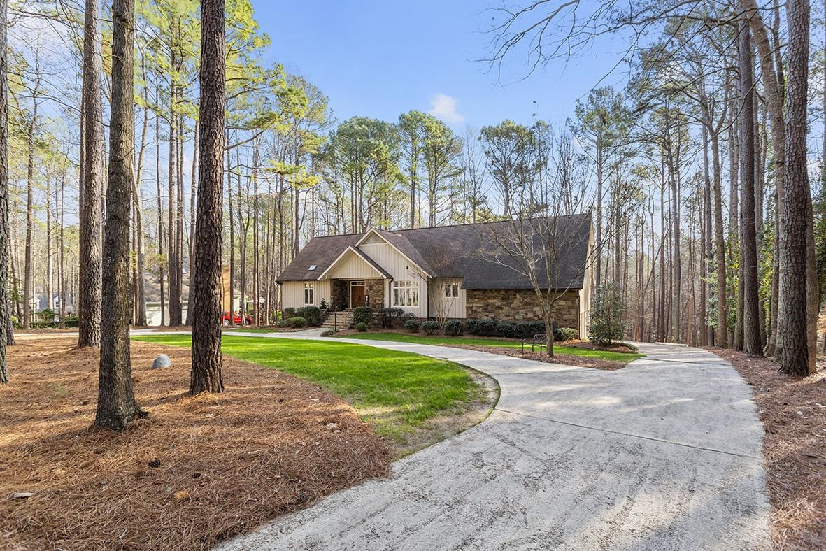 8120 Hawkshead Road Wake Forest, NC 27587 - Photo 8 of 70 a front view of a house with a yard table and chairs