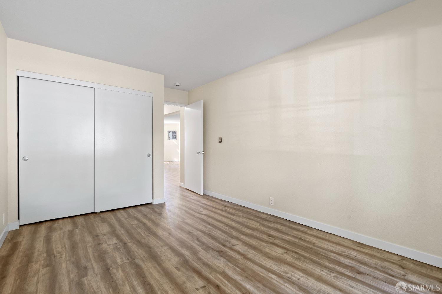 1862 Ellis Street, Unit B San Francisco, CA 94115 - Photo 32 of 41 a view of an empty room with wooden floor