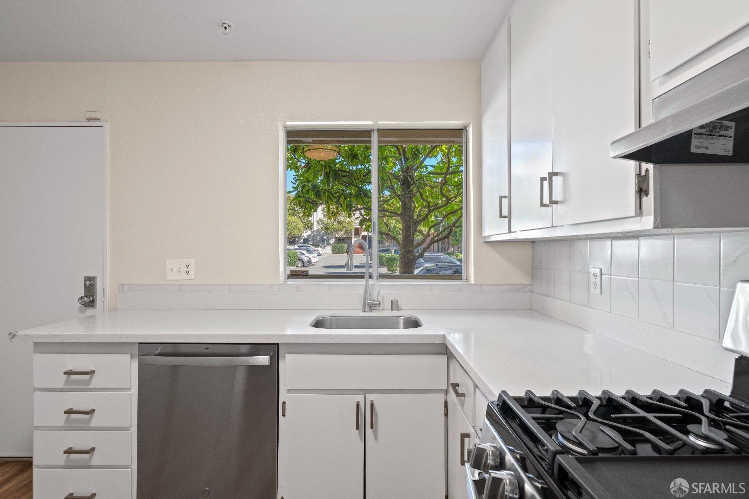 1862 Ellis Street, Unit B San Francisco, CA 94115 - Photo 9 of 41 a kitchen with a sink stove top oven and cabinets