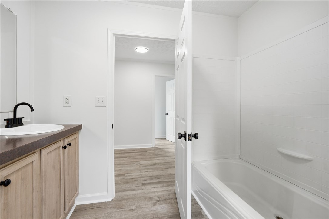 112 Sir Francis Drake Way Liberty, SC 29657 - Photo 20 of 42 This bathroom features a contemporary vanity with sleek hardware and a classic bathtub for ultimate relaxation.