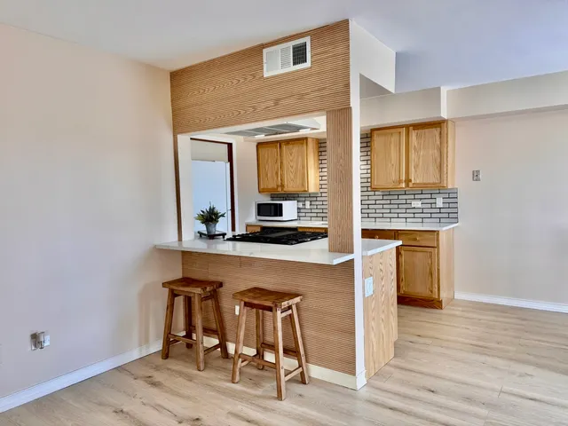 a kitchen with a table and chairs