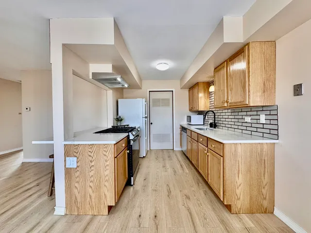 a kitchen with stainless steel appliances granite countertop a stove and a sink