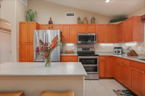 a kitchen with stainless steel appliances granite countertop a stove a sink and a microwave