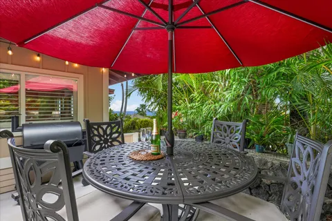 a view of patio with chairs under an umbrella