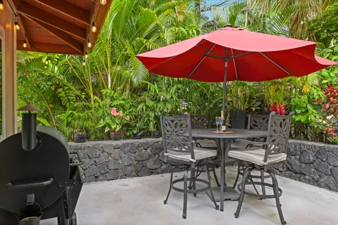 a view of backyard with seating space and wooden floor
