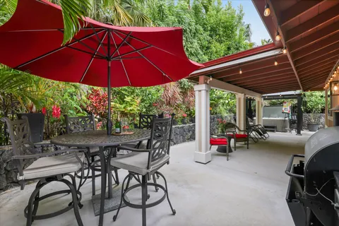 a view of a patio with a table and chairs