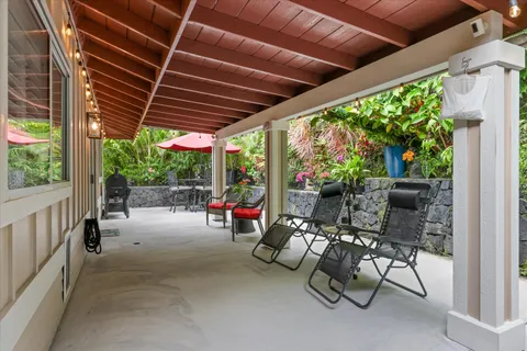 a view of patio with a table and chairs under an umbrella