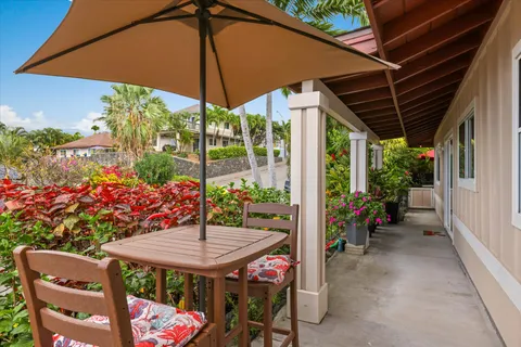 a view of an outdoor sitting area with yellow umbrella