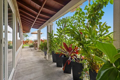 a spacious bedroom with a bed and a flat tv screen on dresser