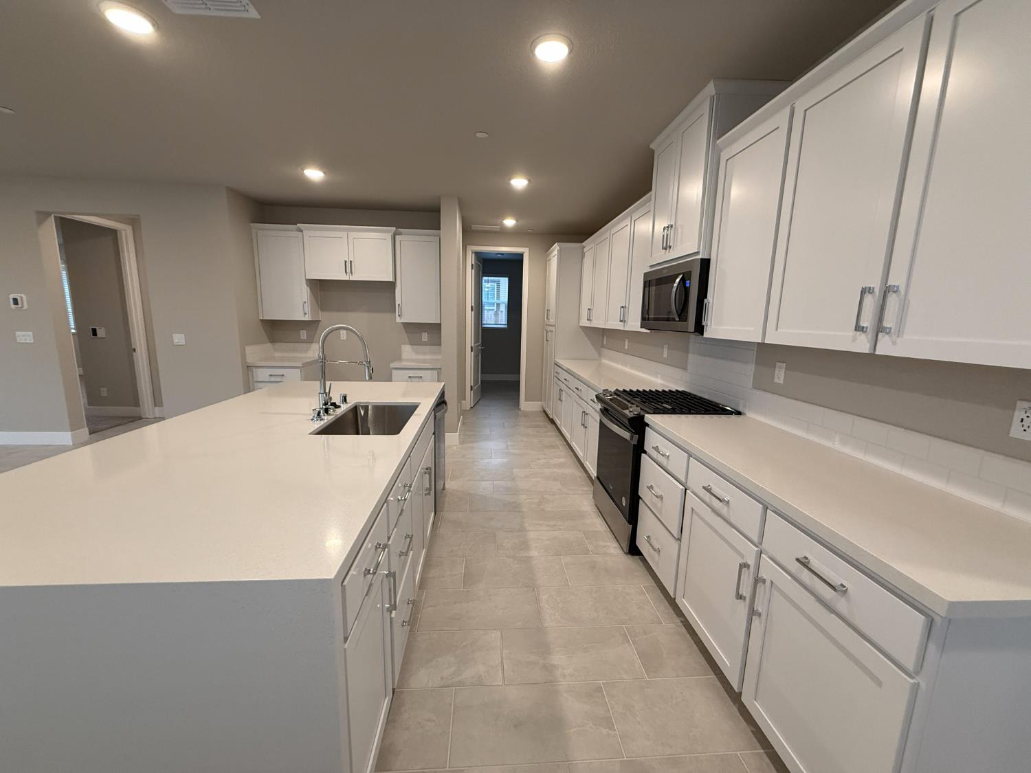 3054 Banano Way Rancho Cordova, CA 95742 - Photo 4 of 5 a large kitchen with kitchen island a sink dishwasher stove and cabinets