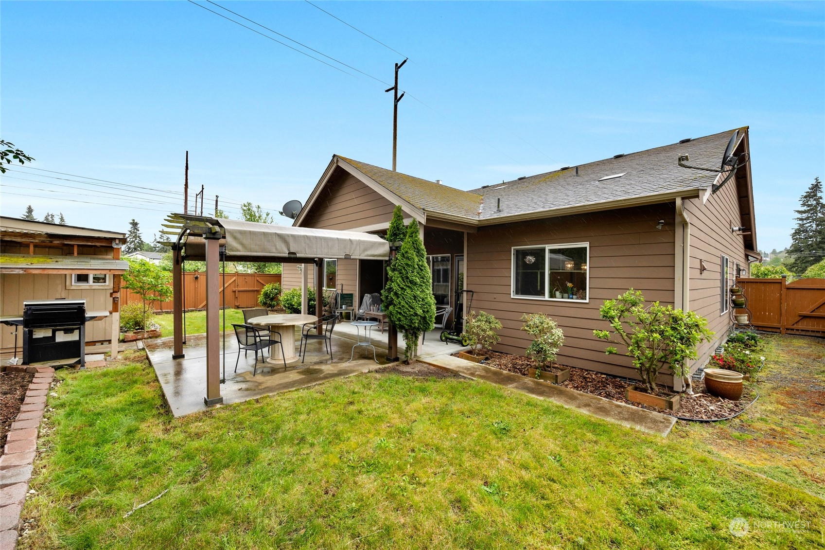 7521 Broadway Everett, WA 98203 - Photo 25 of 25 a view of a house with backyard sitting area and furniture