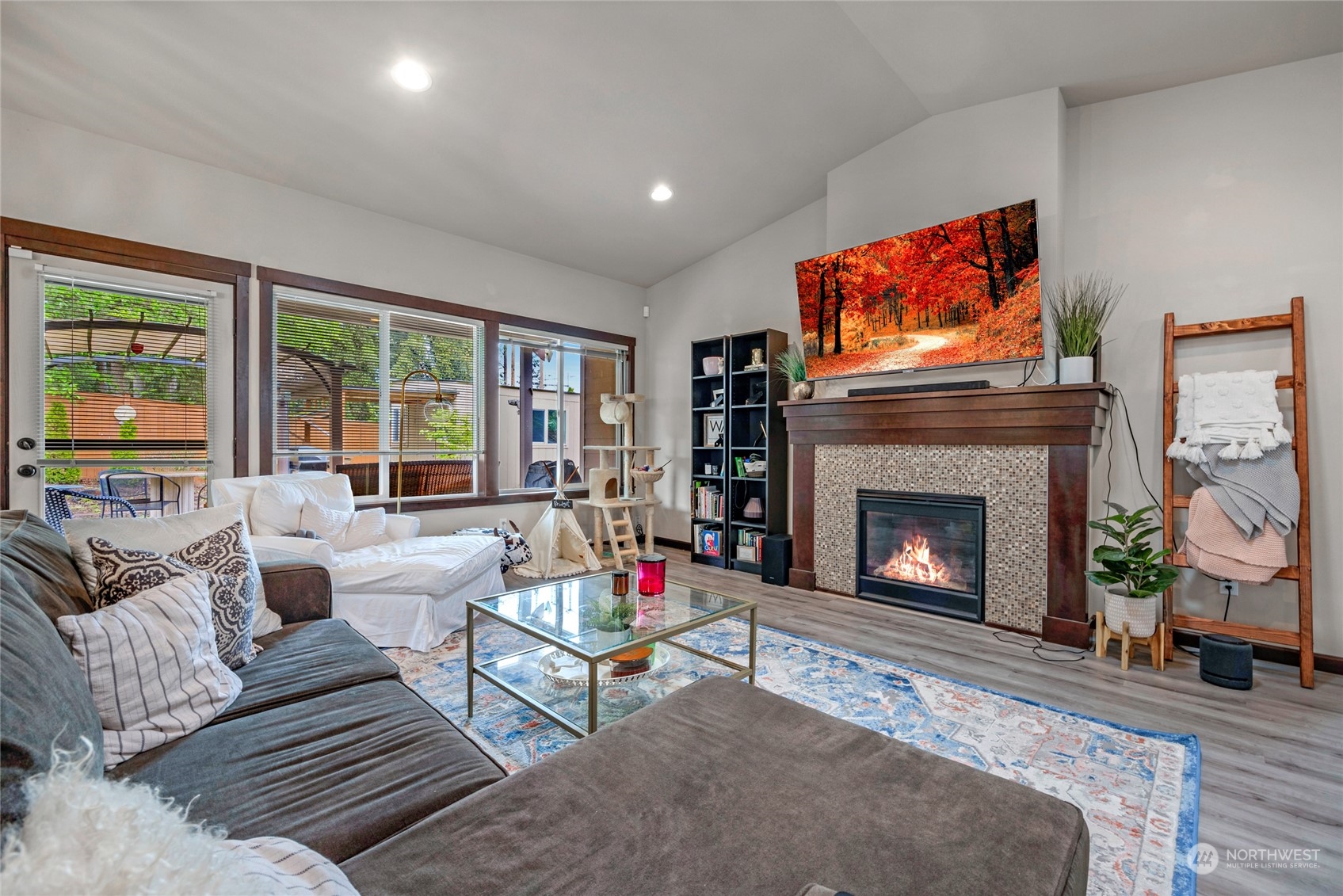 7521 Broadway Everett, WA 98203 - Photo 6 of 25 a living room with furniture a flat screen tv and a fireplace