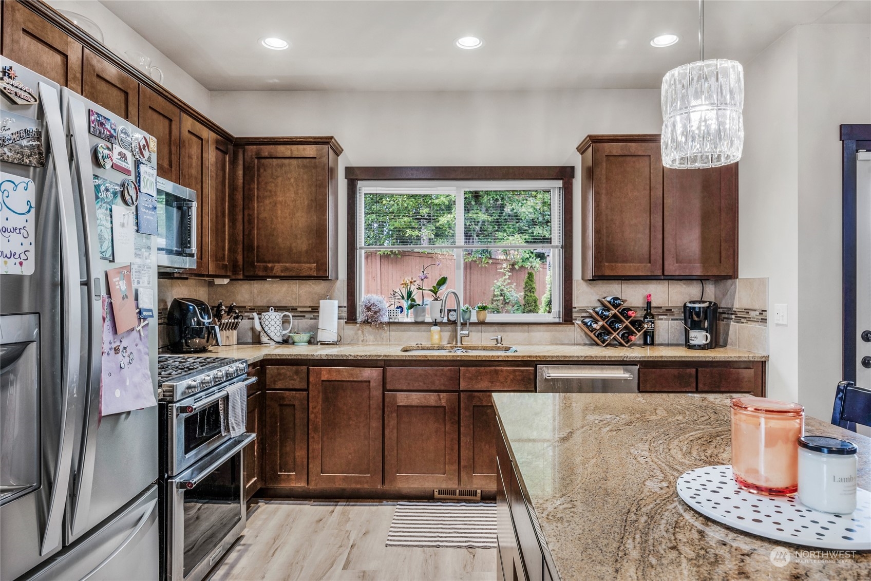 7521 Broadway Everett, WA 98203 - Photo 10 of 25 a kitchen with stainless steel appliances granite countertop a sink and wooden cabinets