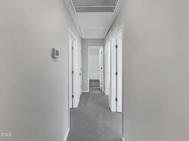 a view of a hallway with wooden shelves