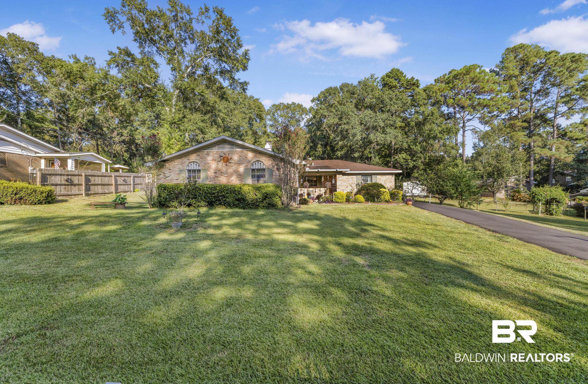 2573 E Road Mobile, AL 36693 - Photo 9 of 45 View of front facade with brick siding and view of scattered trees