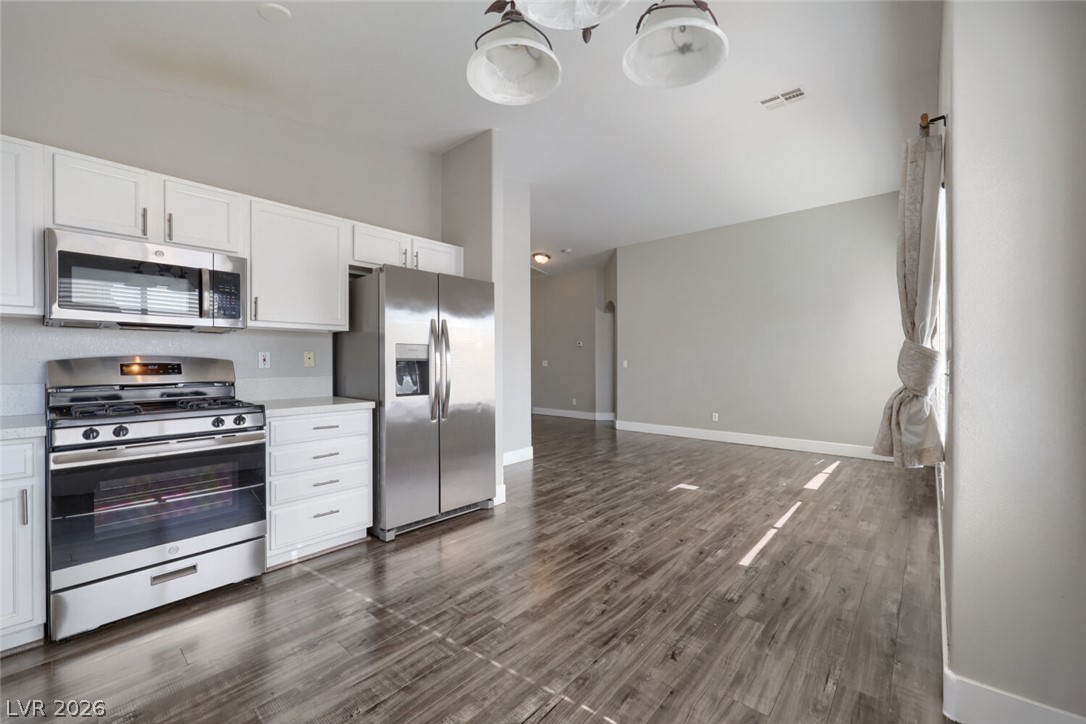5985 High Steed Street, Unit 101 Henderson, NV 89011 - Photo 12 of 38 A sleek, open kitchen with modern appliances flows into a versatile living space.
